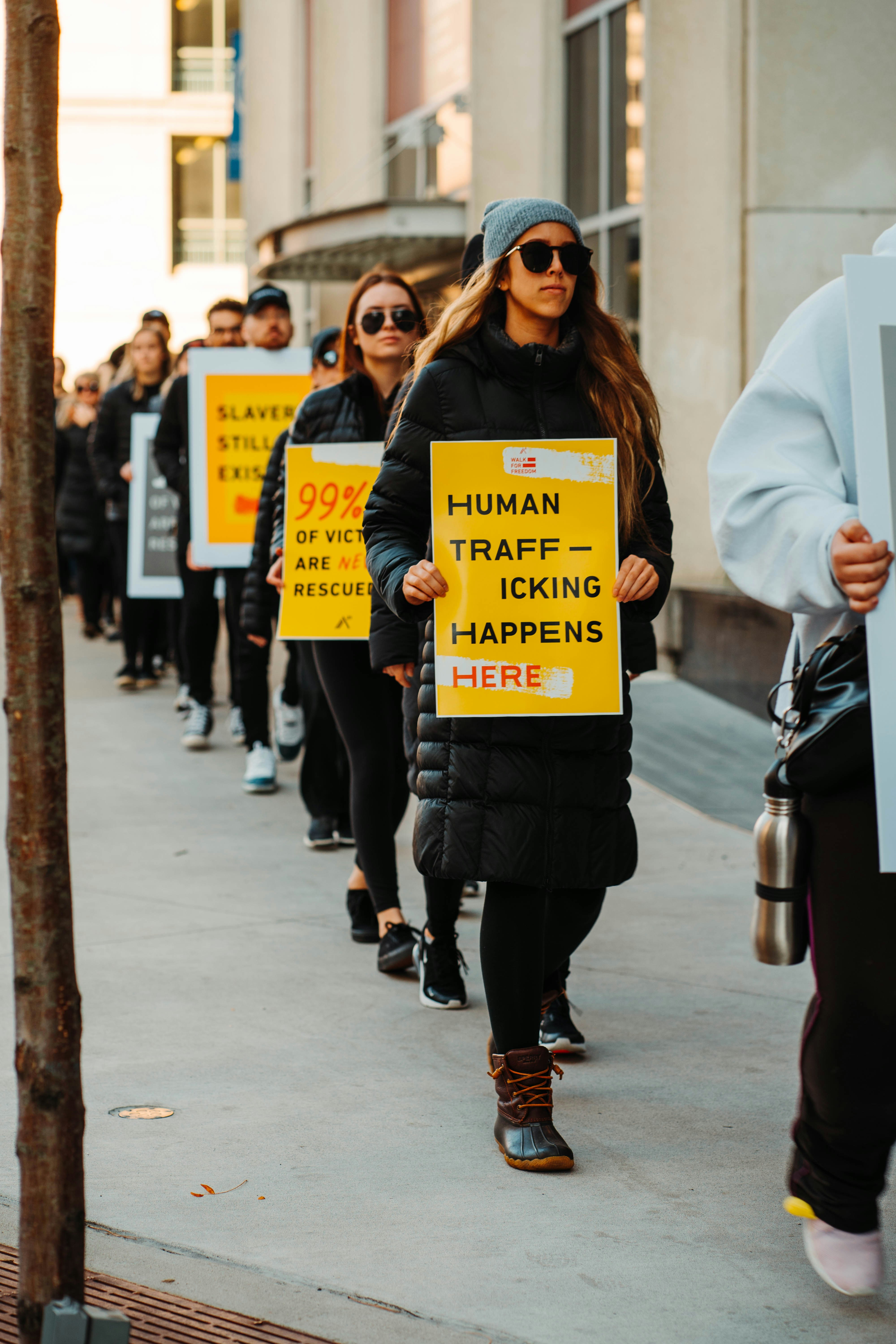 Healthcare professional holding anti-human trafficking sign